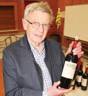 Lover of wine Alan Evans with one of his favourites a bottle of 1997 Chateau Troplong Mondot.