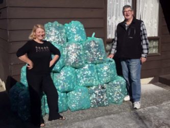 Anne Megget & Wayne Kennedy with 27 bags of wine bottle screwcaps for Kidney Kids