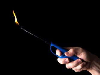 Use a long lighter to keep your hand away from the flame. EugeneTomeev/Getty Images