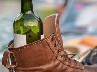 Sit the bottle of wine securely inside the shoe, then bang it against the wall to force the cork out. AlanMBarr/Getty Images